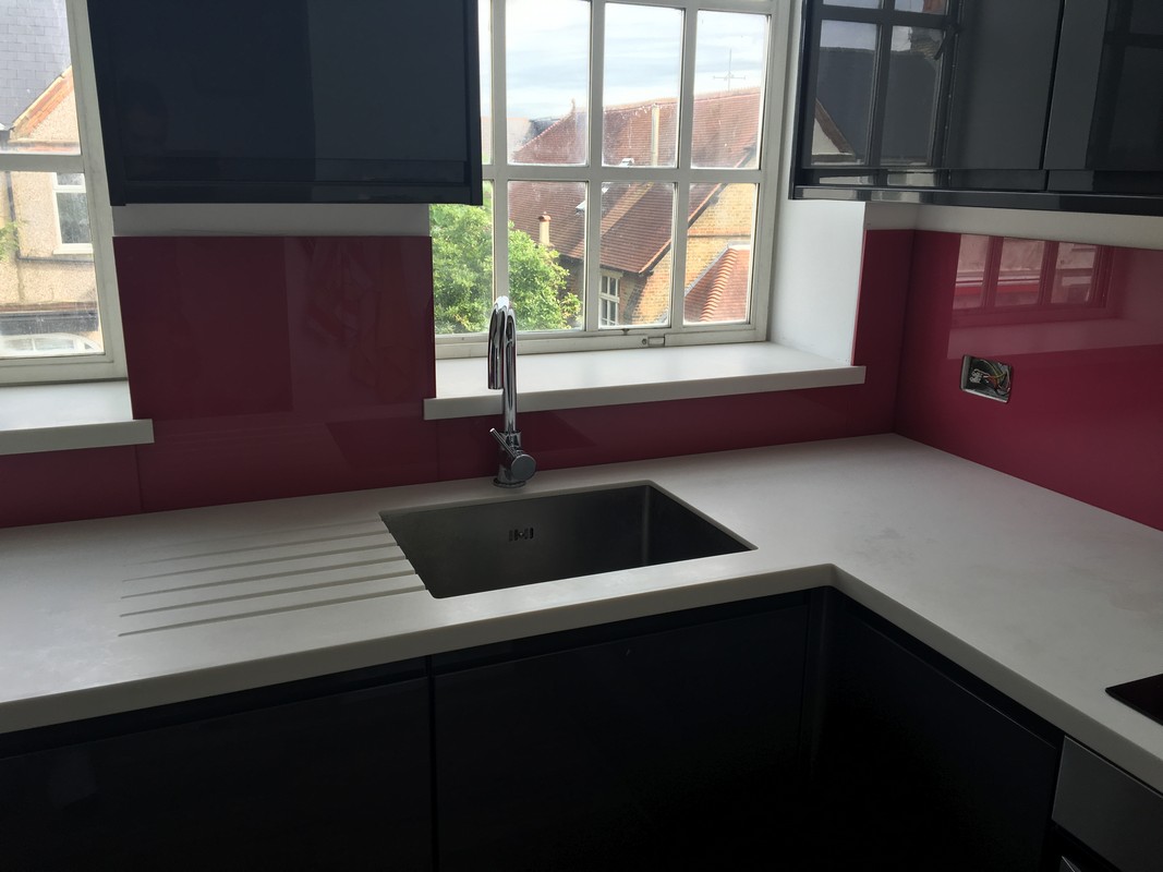 Deep plum coloured glass splashback in modern Crouch End kitchen