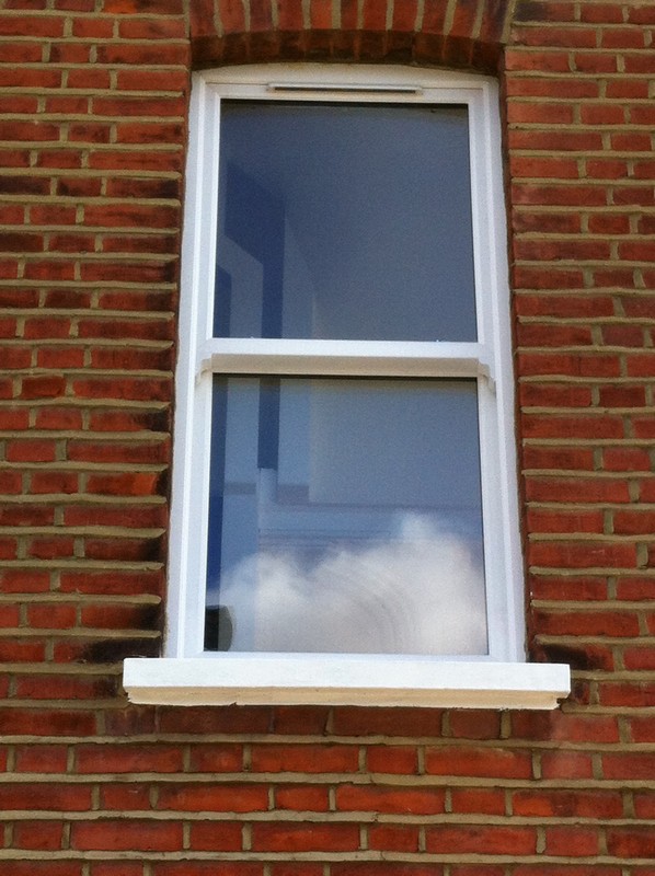 uPVC sash window on Victorian red brick house in Crouch End
